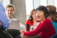 Woman Wearing Red Talking at a Meeting