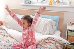 Little Girl Waking Up in Bead